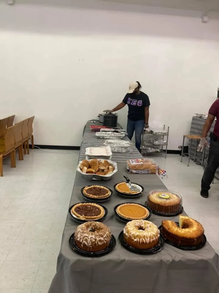 A long table of homemade pies and cakes in the fellowship hall